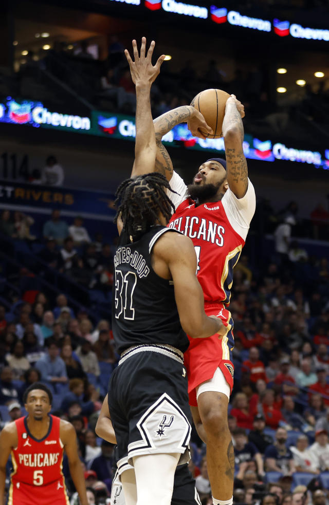 New Orleans Pelicans forward Brandon Ingram (14) shoots the ball over San Antonio Spurs forward Keita Bates-Diop (31) in the first half of an NBA basketball game in New Orleans, Tuesday, March 21, 2023. (AP Photo/Tyler Kaufman)