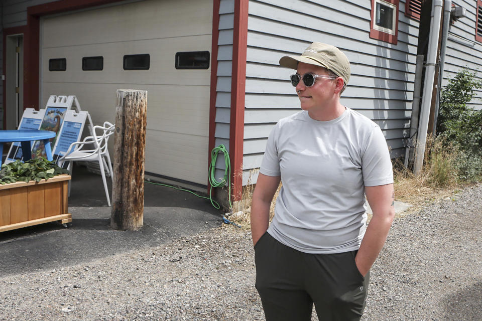 Ash Hermanowski, the food access and operations manager of the Jackson Cupboard, poses for a portrait on Wednesday, Aug. 24, 2022, in Jackson Hole, Wyo. Hermanowksi hands out meals from a commercial garage downtown after the nonprofit was forced out of a previous location by a malfunctioning sprinkler. As the Federal Reserve's annual Jackson Hole economic symposium gets under way Thursday, some of the very problem federal officials are grappling with – high inflation, soaring home prices, and stark financial inequality – are all too visible in the idyllic mountain setting where the economic conference takes place. (AP Photo/Amber Baesler)