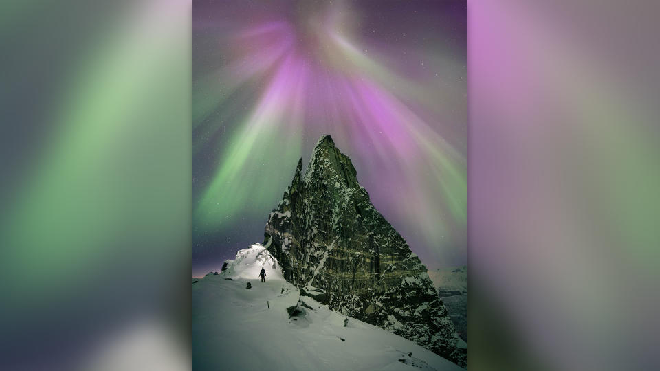 Purple and green northern lights over Otertinden, Norway.