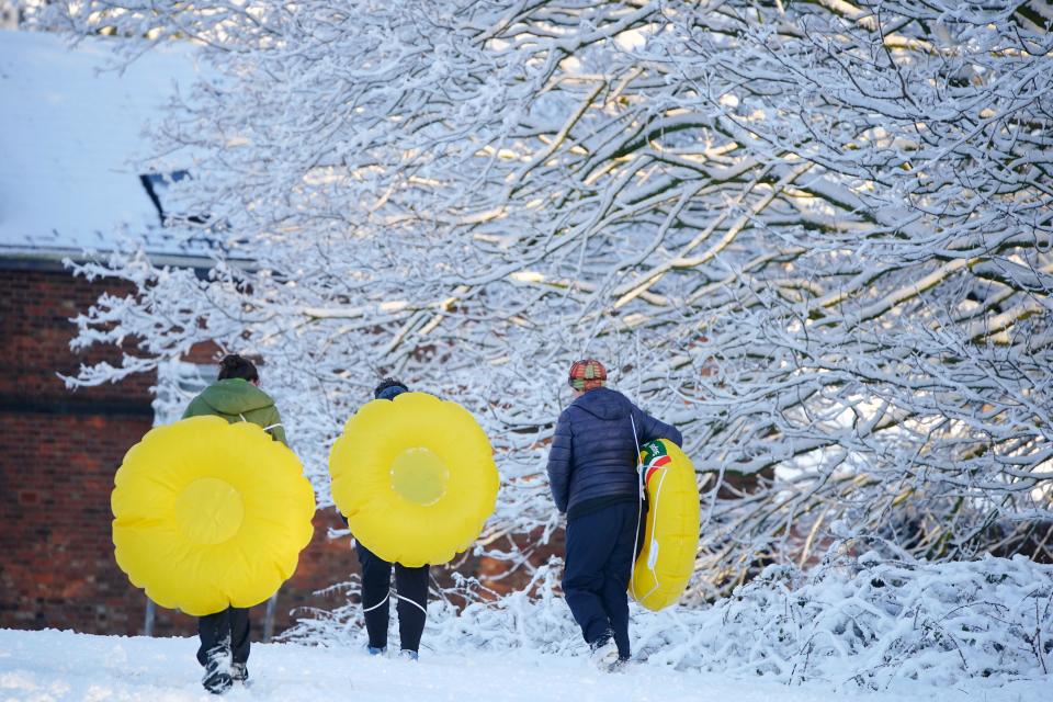 People take advantage of the snowy weather with inflatables to use as sledges at Camp Hill in Woolton, Liverpool. Much of Britain is facing another day of cold temperatures and travel disruption after overnight lows dropped below freezing for the bulk of the country. A 