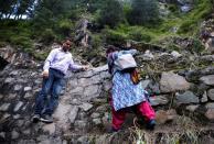 The Wider Image: Doctors scale rockslides, invoke gods to vaccinate Himalayan villages