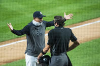 New York Yankees manager Aaron Boone, left, argues with home plate umpire John Tumpane during the first inning of a baseball game against the Miami Marlins at Yankee Stadium, Friday, Sept. 25, 2020, in New York. (AP Photo/Corey Sipkin)