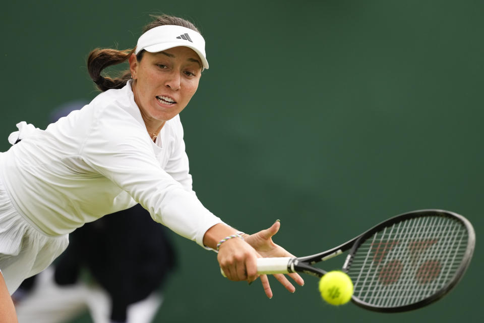 Jessica Pegula of the United States plays a backhand return to compatriot Ashlyn Krueger during their first round match at the Wimbledon tennis championships in London, Tuesday, July 2, 2024. (AP Photo/Alberto Pezzali)