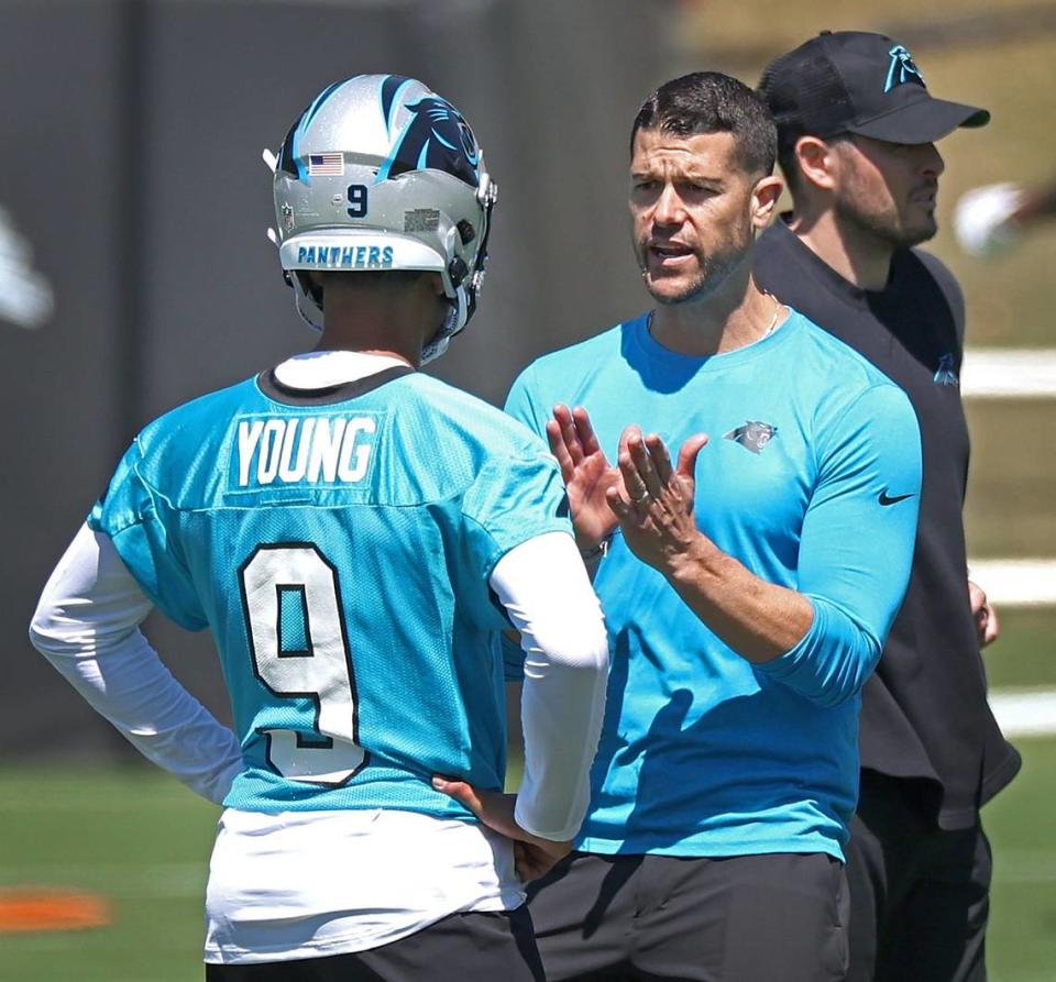 Carolina Panthers head coach Dave Canales, right, speaks with quarterback Bryce Young, left, during the team’s voluntary minicamp practice on Tuesday, April 23, 2024.