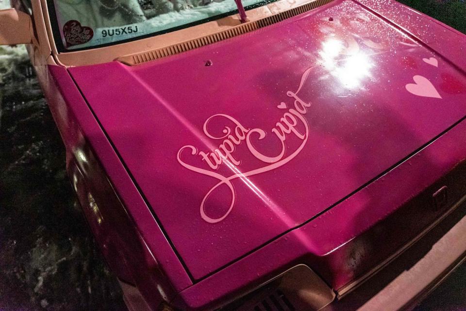 a pink car hood with writing on it