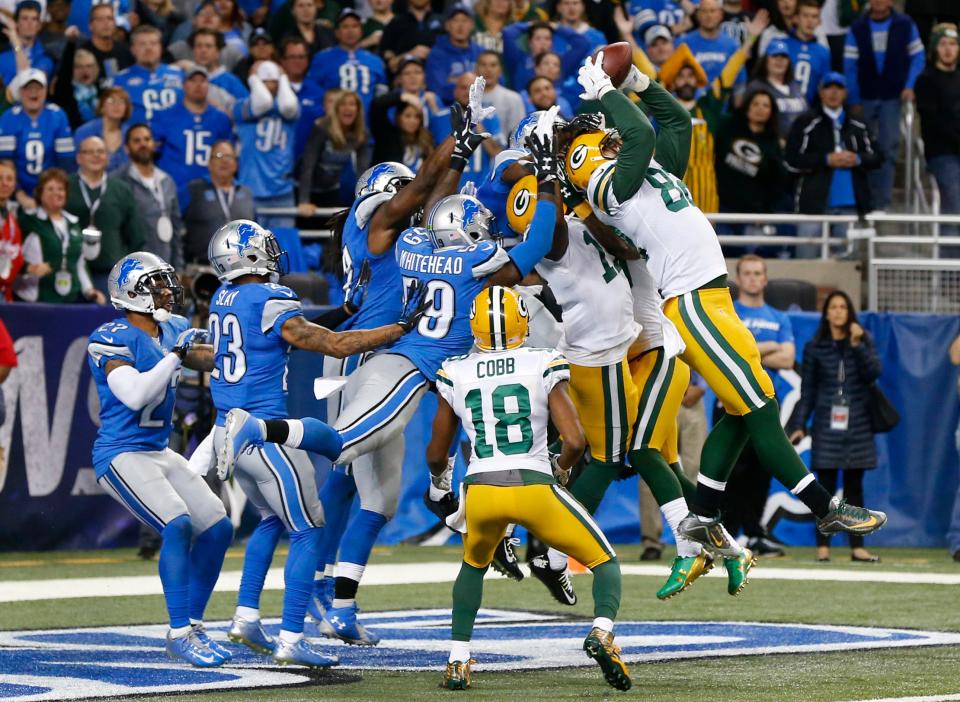 Packers tight end Richard Rodgers, right, catches a 61-yard Hail Mary touchdown pass thrown by Aaron Rodgers with no time remaining to beat the Lions, 27-23, in Detroit on Dec. 3, 2015.