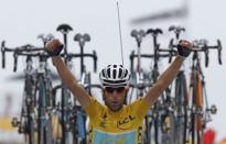 Race leader Astana team rider Vincenzo Nibali of Italy celebrates as he crosses the finish line to win the 145.5km 18th stage of the Tour de France cycling race between Pau and Hautacam, July 24, 2014. REUTERS/Jean-Paul Pelissier