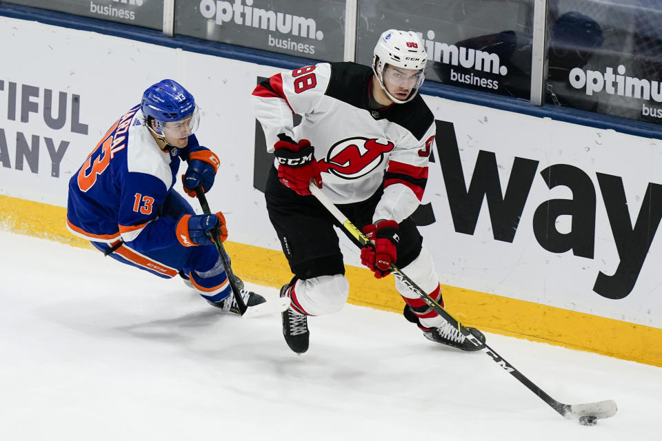 New York Islanders' Mathew Barzal (13) defends against New Jersey Devils' Kevin Bahl (88) during the third period of an NHL hockey game Thursday, May 6, 2021, in Uniondale, N.Y. The Devils won 2-1. (AP Photo/Frank Franklin II)