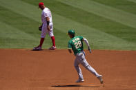 Oakland Athletics' Matt Olson, right, passes Los Angeles Angels first baseman Albert Pujols as he rounds first after hitting a solo home run during the first inning of a baseball game Wednesday, Aug. 12, 2020, in Anaheim, Calif. (AP Photo/Mark J. Terrill)