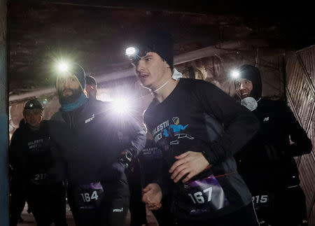 Participants take part in the "Milestii Mici Wine Run 2019" race, at a distance of 10 km in the world's largest wine cellars in Milestii Mici, Moldova January 20, 2019. Picture taken January 20, 2019. REUTERS/Gleb Garanich