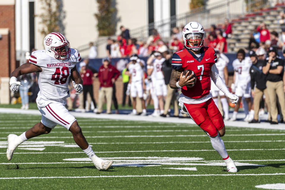 Liberty's Kaidon Salter, right, runs the ball for a touchdown past UMass' Jerry Roberts Jr. during the first half of an NCAA college football game, Saturday, Nov. 18, 2023, in Lynchburg, Va. (AP Photo/Robert Simmons)