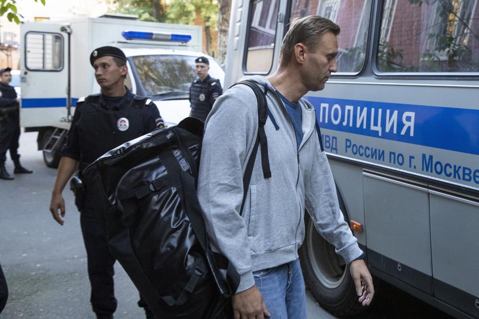 Russian opposition leader Alexei Navalny, right, leaves a court for jail surrounded by police officers in Moscow, Russia, Monday, Aug. 27, 2018. A court in Moscow has sentenced Russian opposition leader Alexei Navalny to a month in jail for an unsanctioned protest rally. Navalny’s arrest outside his home on Saturday came as a surprise since police detained him over a protest rally held in January. (AP Photo/Pavel Golovkin)