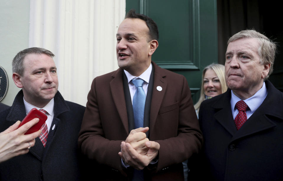 Ireland's Prime Minister Leo Varadkar, center, with Fine Gael candidates for the Clare constituency Joe Carey, left, and Pat Breen, in Ennis, Ireland, Friday Feb. 7, 2020, on the last day of campaigning ahead of the general election. Irish voters will choose a new parliament on Saturday, and may have bad news for the two parties that have dominated the country’s politics for a century, Fianna Fail and Fine Gael. Polls show a surprise surge for Sinn Fein, the party historically linked to the Irish Republican Army and its violent struggle for a united Ireland. (Brian Lawless/PA via AP)