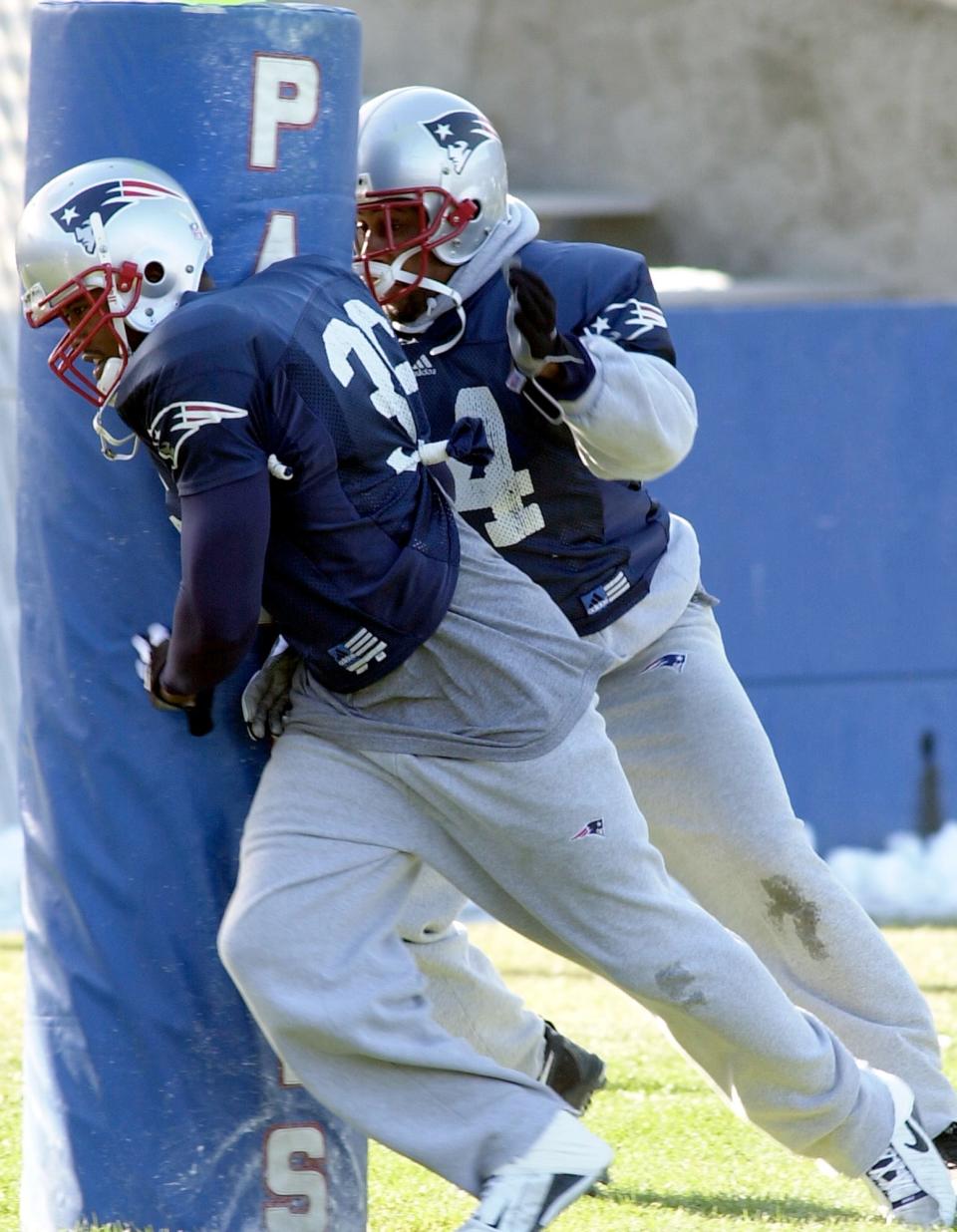 New England Patriots' defensive backs Lawyer Milloy (36) and Ty Law (24) workout during practice at Foxboro Stadium in Foxboro, Mass., Wednesday, Jan. 16, 2002. The Patriots are preparing to play the Oakland Raiders in the AFC second-round game on Saturday, Jan. 19. (AP Photo/ Robert E.  Klein)