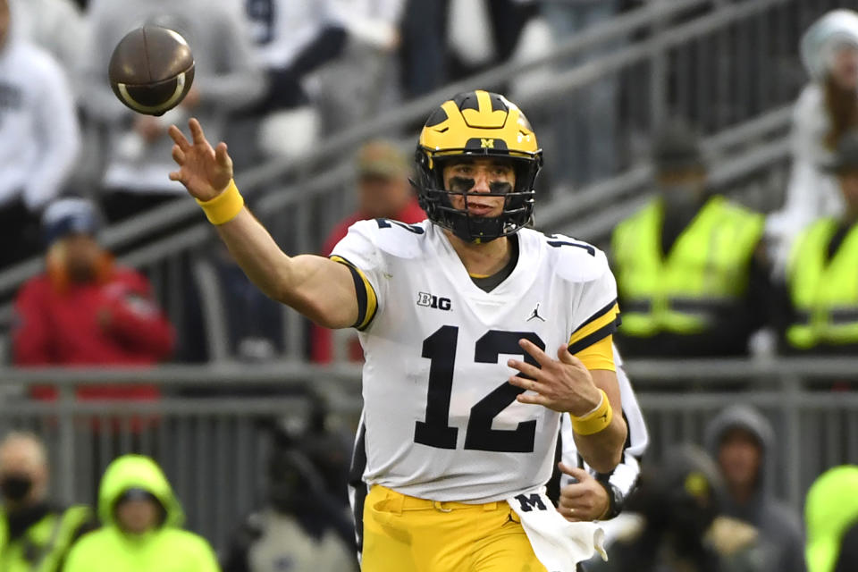 FILE - Michigan quarterback Cade McNamara throws a 47-yard touchdown pass to tight end Erick All in the fourth quarter against Penn State during an NCAA college football game in State College, Pa., Nov. 13, 2021. Michigan scored points on half of McNamara's drives last season. (AP Photo/Barry Reeger, File)