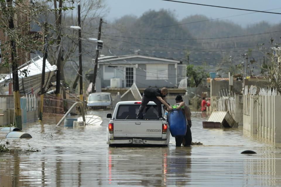 Residents evacuate after the passing of Hurricane Maria, in Toa Baja, Puerto Rico, Friday, September 22, 2017.AP