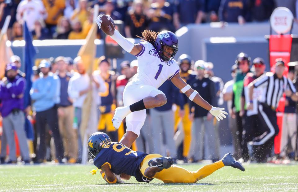 TCU wide receiver Quentin Johnston (1) makes a catch and tries to make West Virginia cornerback Charles Woods (9) miss during the third quarter at Mountaineer Field at Milan Puskar Stadium.