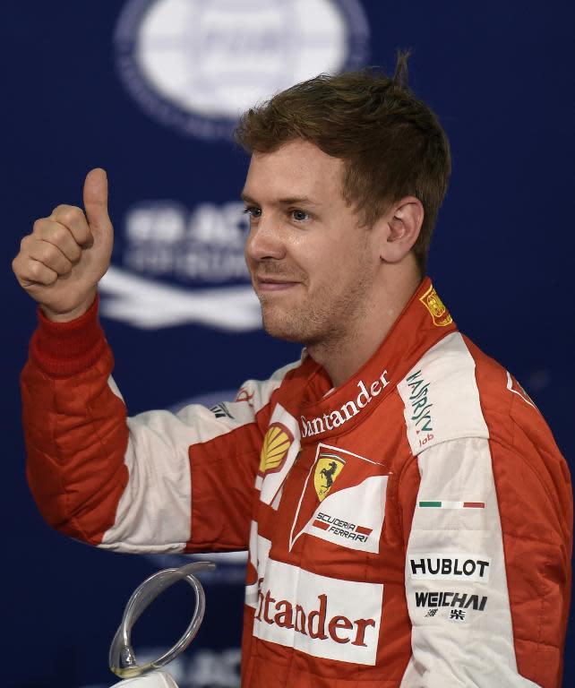 Ferrari driver Sebastian Vettel on the podium after winning second position on the starting grid following the qualification session for the Bahrain Grand Prix on April 18, 2015