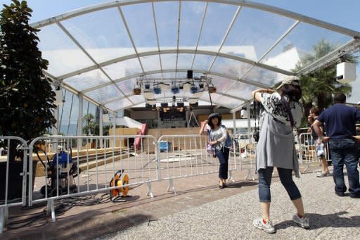 People take pictures in front of the "Palais des Festivals", on May 12 in Cannes, southeastern France. Arthouse directors and Hollywood royalty will converge on the French Riviera for two weeks from Wednesday as the Cannes Film Festival rolls out the red carpet for the giants and mavericks of the movie galaxy