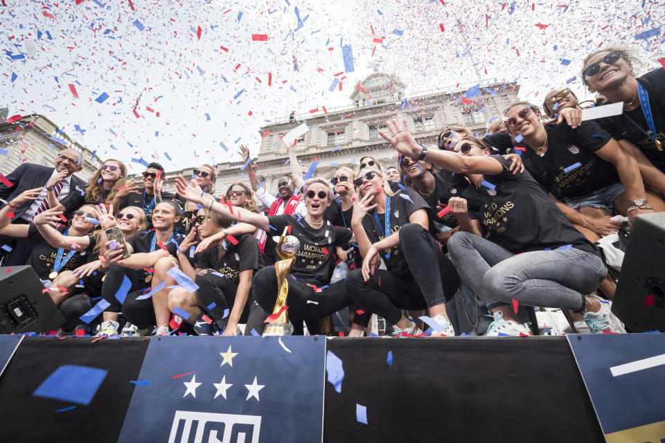 Members of the USA Women's National Soccer Team stand in front of the 2019 FIFA World Cup Trophy and get showered by confetti after the City Hall Ceremony. Each member of the team got a key to the city after winning the 2019 FIFA World Cup Championship title, their fourth, played in France against Netherlands, at the City Hall Ceremony in the Manhattan borough of New York on July 10, 2019, USA. (Photo by Ira L. Black/Corbis via Getty Images)