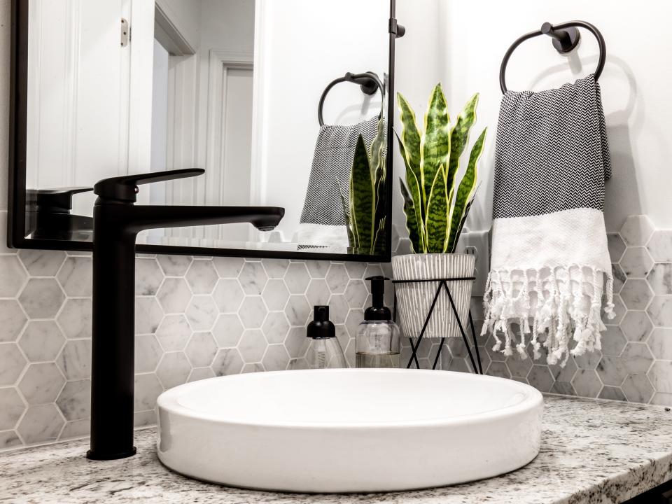 Bathroom with matte black faucet and towel holder