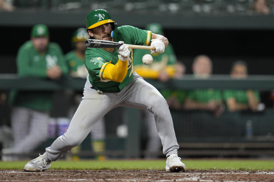 Oakland Athletics' Kevin Smith hits an RBI sacrifice bunt against the Baltimore Orioles during the eighth inning of a baseball game Wednesday, April 12, 2023, in Baltimore. The Athletics won 8-4. (AP Photo/Jess Rapfogel)