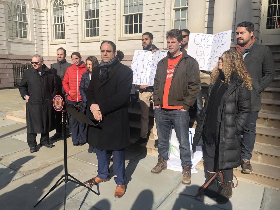 New York City Councilman Costa Constantinides, flanked by housing advocates and environmentalists, announces the introduction of his bill three months after he first said he'd draft legislation to cut emissions from big buildings 80 percent by 2050.  (Alexander C. Kaufman / HuffPost)