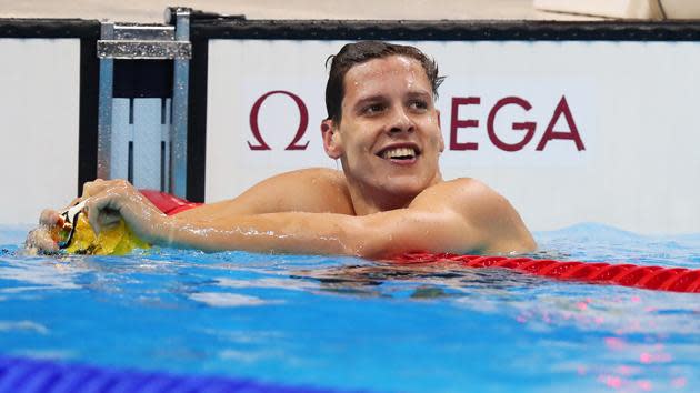 Mitch Larkin all smiles after winning his backstroke heat.