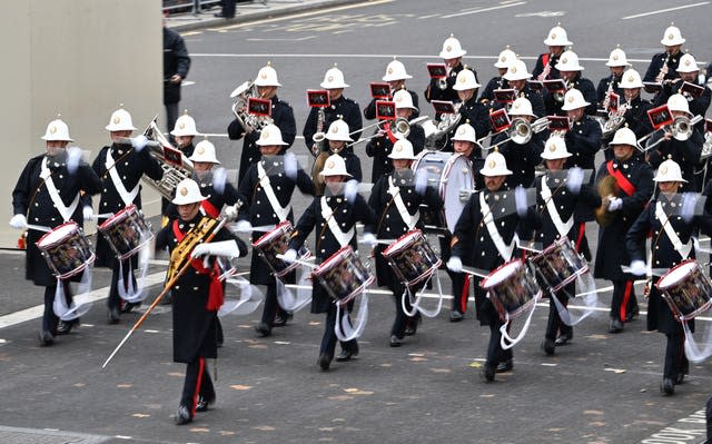 Bandsmen march past the Cenotaph