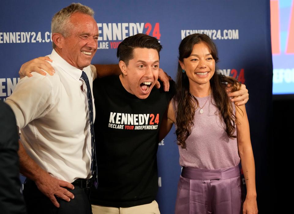 Independent presidential candidate Robert F. Kennedy Jr., and his running mate Nicole Shanahan pose for a photo with Jose Saenz at a campaign rally at Brazos Hall Monday May 13, 2024.