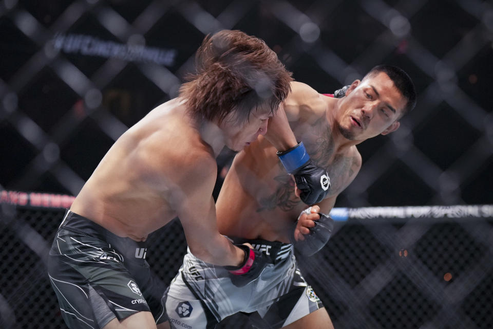 Jun 24, 2023; Jacksonville, Florida, USA; Zhalgas Zhumagulov (red gloves) fights Joshua Van (blue gloves) in a flyweight bout during UFC Fight Night at VyStar Veterans Memorial Arena. Mandatory Credit: David Yeazell-USA TODAY Sports