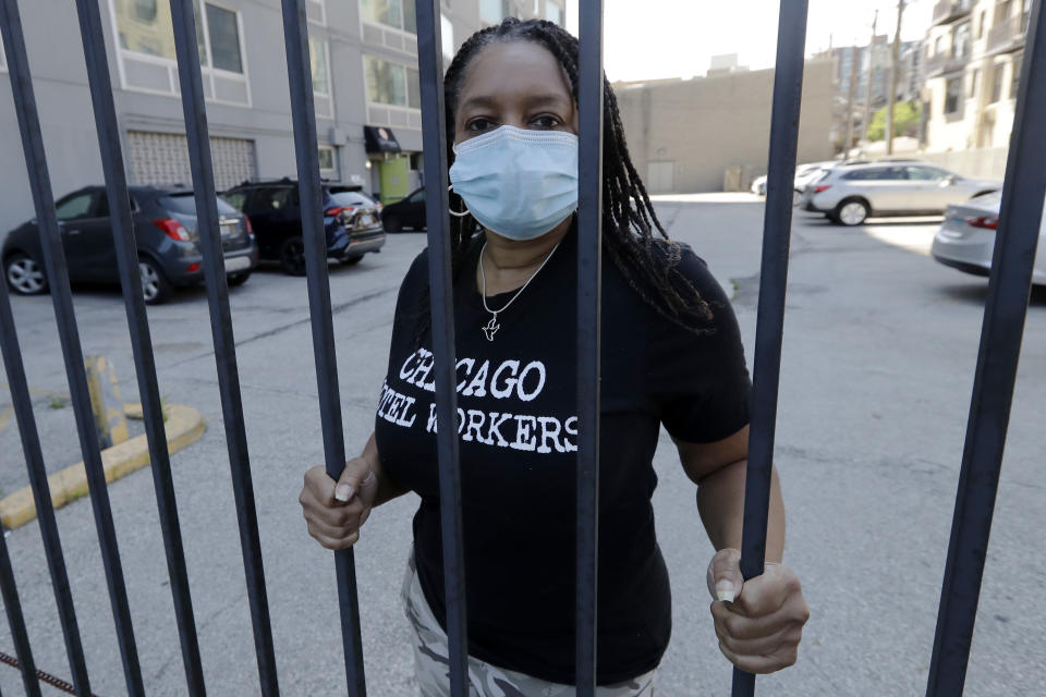 Roushaunda Williams poses for a photo in Chicago Thursday, July, 23, 2020. Financial challenges keep piling up for Williams months after she lost her job of nearly 20 years tending bar at the Palmer House Hilton Hotel in downtown Chicago. Potential reopening dates for the hotel have been pushed back, Williams said, and hospitality jobs remain scarce. (AP Photo/Nam Y. Huh)