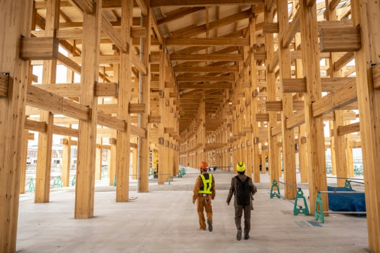 Des ouvriers sous le "grand toit", l'une des plus grandes structures en bois jamais construites au monde, sur le chantier de l'Exposition universelle 2025, le 2 avril 2024 à Osaka, au Japon (Yuichi YAMAZAKI)