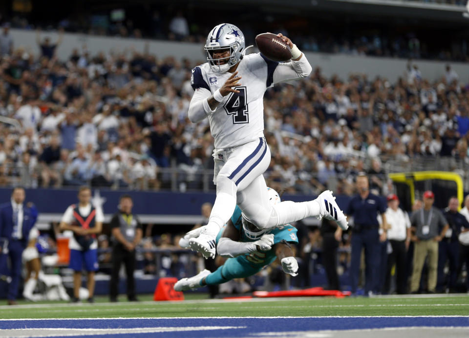 FILE- In this Sunday, Sept. 22, 2019, file photo, Dallas Cowboys quarterback Dak Prescott (4) gets past Miami Dolphins defensive back Walt Aikens (35) and into the end zone for a touchdown in the second half of an NFL football game in Arlington, Texas. With the Cowboys at 3-0, their fans are beginning to see America’s Team as a team of destiny. (AP Photo/Ron Jenkins, File)