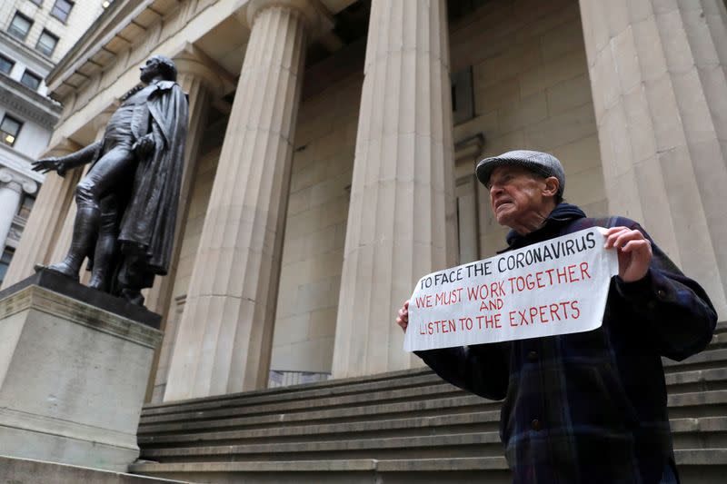 Bill Johnsen of Staten Island, 71, stands on the steps of Federal Hall on Wall Street, after more cases of coronavirus were confirmed in Manhattan, New York City