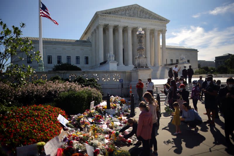 People gather in front of the U.S. Supreme Court following the death of U.S. Supreme Court Justice Ruth Bader Ginsburg, in Washington