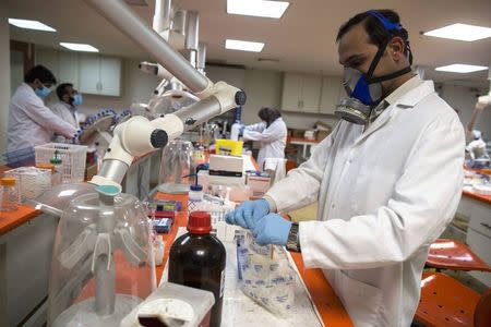 Forensic scientists analyze samples in the Toxicology department at Punjab Forensic Science Agency in Lahore January 13, 2015. REUTERS/Zohra Bensemra