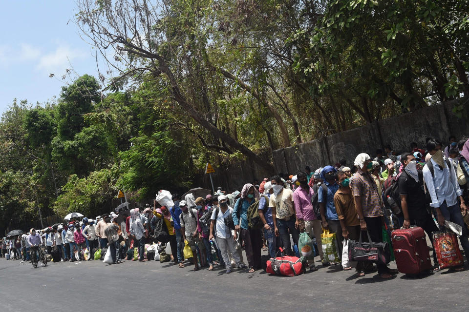 Migrant workers queue outside a railway station in Mumbai after the government eased a nationwide lockdown as a preventive measure against the coronavirus pandemic.  (Punit Paranjpe / AFP - Getty Images)