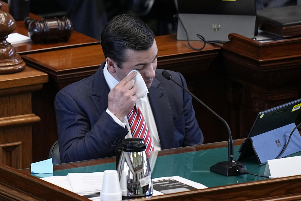 Whistleblower witness Ryan Vassar, former deputy attorney general, left, wipes away tears as he testifies during day three of the impeachment trial for Texas Attorney General Ken Paxton in the Senate Chamber at the Texas Capitol, Thursday, Sept. 7, 2023, in Austin, Texas. (AP Photo/Eric Gay)