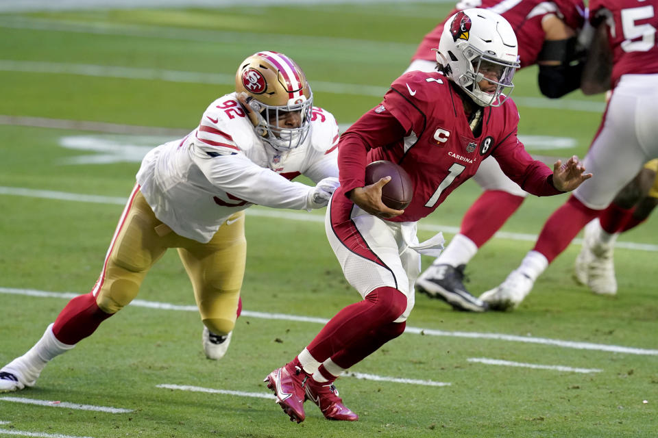 Arizona Cardinals quarterback Kyler Murray (1) eludes the reach of San Francisco 49ers defensive end Kerry Hyder (92) during the first half of an NFL football game, Saturday, Dec. 26, 2020, in Glendale, Ariz. (AP Photo/Ross D. Franklin)