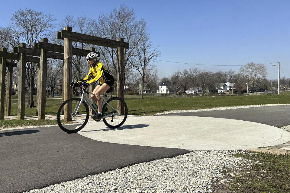 A cyclist rides along the Cardinal Greenway in Muncie, Indiana on Wednesday March 13, 2024. The Cardinal Greenways pathway born from eastern Indiana's abandoned railroad tracks will become a central cog in the Great American Rail Trail — a planned 3,700-mile network of uninterrupted trails spanning from Washington state to Washington, D.C. (AP Photo/Isabella Volmert)