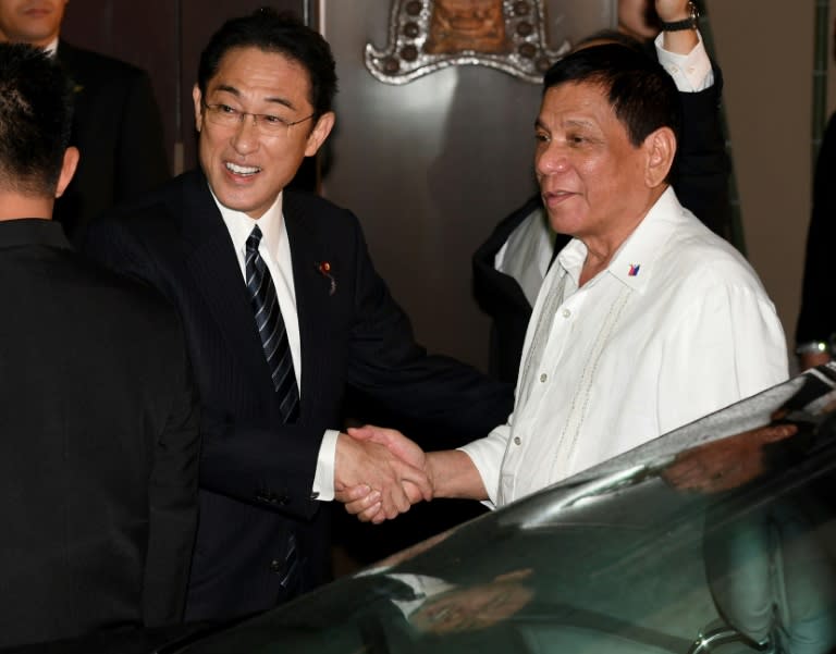 Philippine President Rodrigo Duterte (R) is welcomed by Japanese Foreign Minister Fumio Kishida prior to their dinner meeting in Tokyo, on October 25, 2016