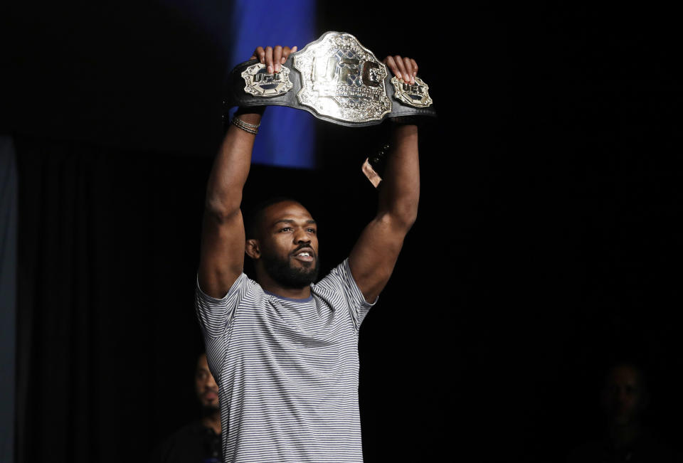 Jon Jones holds up a belt during a UFC 200 mixed martial arts news conference Wednesday, July 6, 2016, in Las Vegas. Jones is scheduled to fight Daniel Cormier in a light heavyweight championship fight at UFC 200 on Saturday. (AP Photo/John Locher)