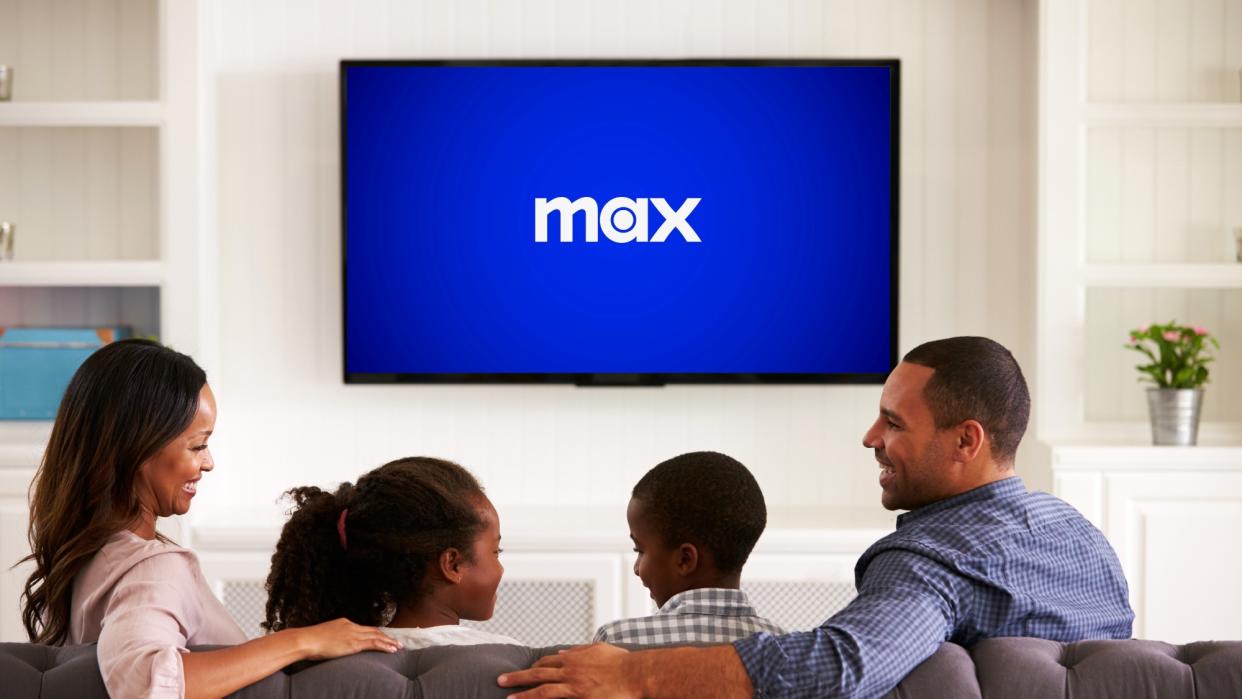  Max logo on a television screen in front of a family. 