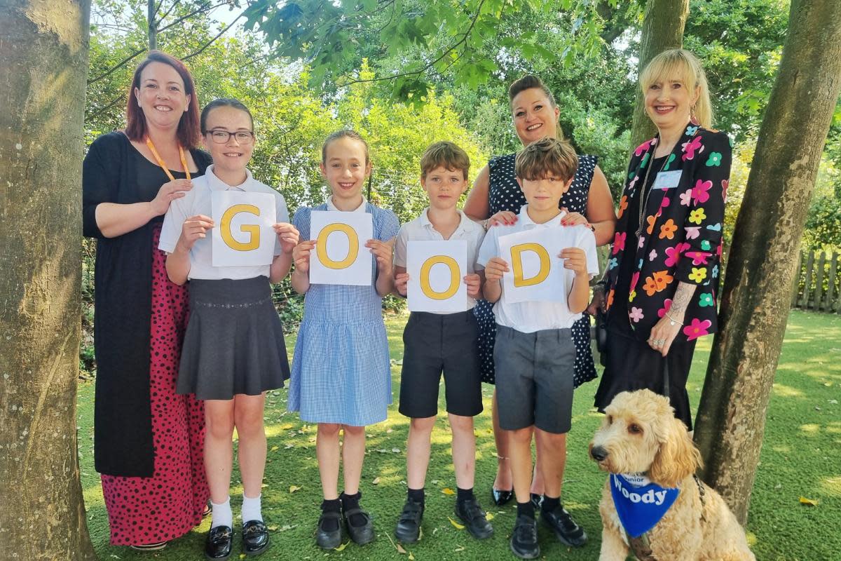 Smiles - Broomgrove staff and pupils celebrate the new Ofsted report alongside school dog Felix <i>(Image: Public)</i>