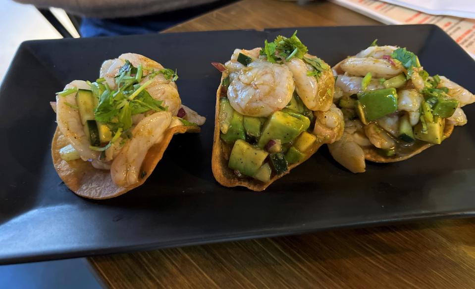 The tostadas de aguachile tatemado ($12.50) are made with shrimp in aguachile, avocado, red onion, cucumber, cilantro and mayonnaise.