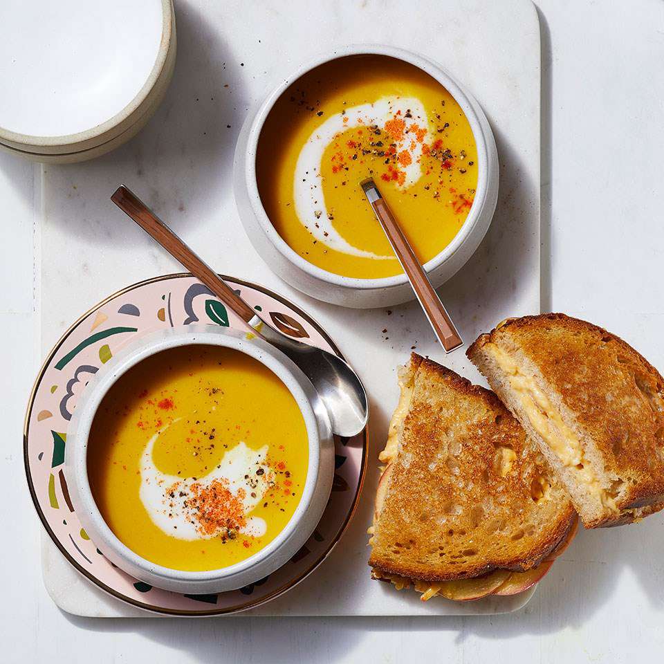 <p>Layering apple slices into grilled cheese sandwiches adds a little crunch to a favorite soup dipper. And creamy butternut squash soup with ginger, cumin and turmeric is a nice change of pace from grilled cheese's usual tomato soup partner. Serve the duo for a comforting and easy weeknight dinner for the family. The soup keeps well in the fridge, so save leftovers for lunch or dinner later in the week.</p>