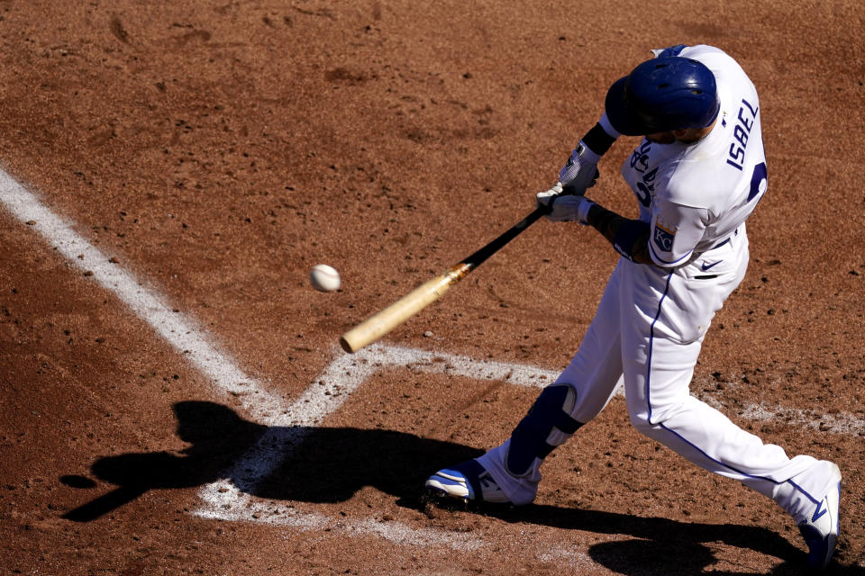 Kansas City Royals' Kyle Isbel hits an RBI single during the first inning of a baseball game against the Texas Rangers Thursday, April 1, 2021, in Kansas City, Mo. (AP Photo/Charlie Riedel)