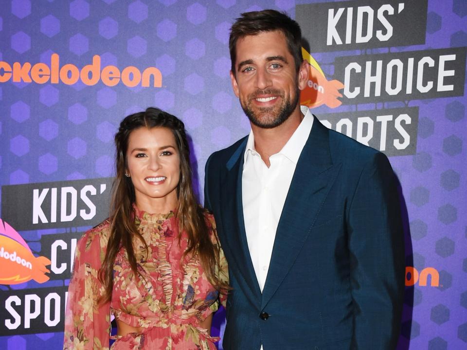 Danica Patrick (L) and NFL player Aaron Rodgers attend the Nickelodeon Kids' Choice Sports 2018 at Barker Hangar on July 19, 2018 in Santa Monica, California