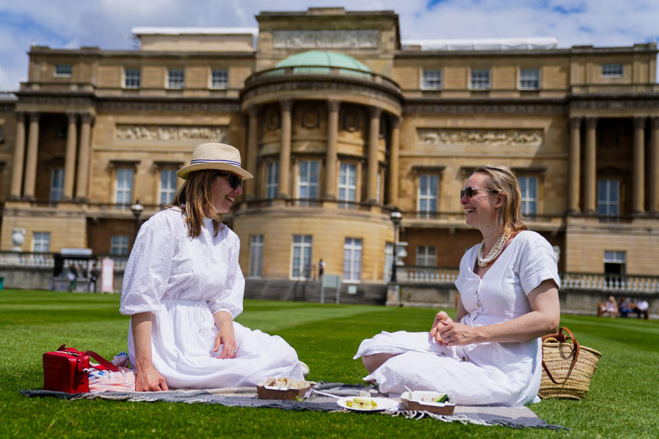 Alex Campbell (left), 38, and Lara Curry, 38 enjoy a picnic on the lawn during a preview of the Garden at Buckingham Palace, Queen Elizabeth II&#39;s official residence in London, which opens to members of the public on Friday. Visitors will be able to picnic in the garden and explore the open space for the first time. Picture date: Thursday July 8, 2021. (Photo by Kirsty O&#39;Connor/PA Images via Getty Images)